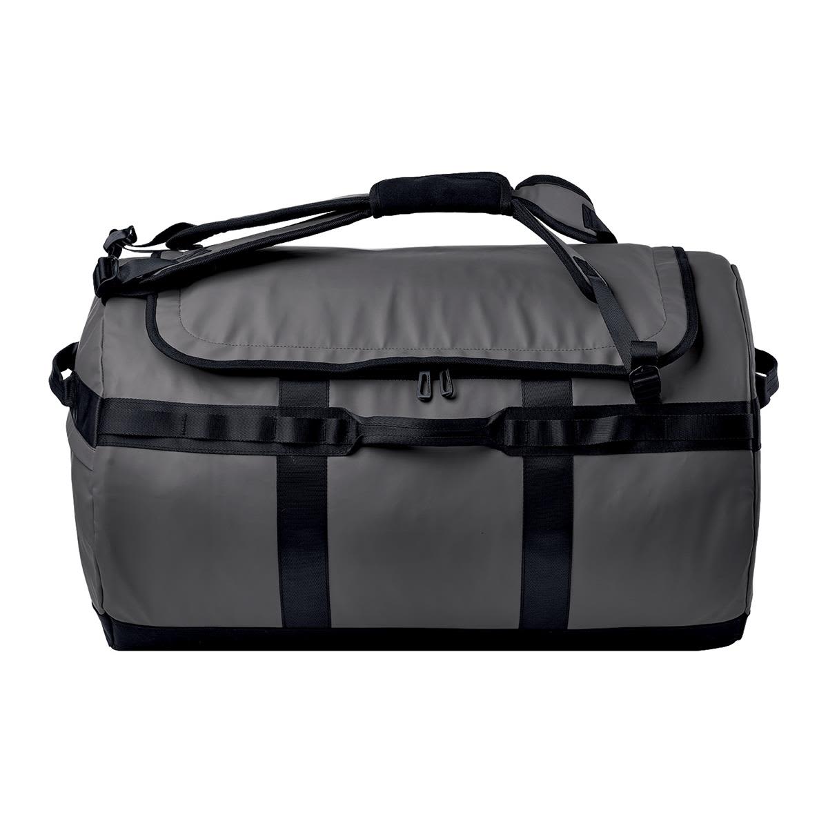 A grey duffle bag with black straps and handles, featuring a logo on the side.