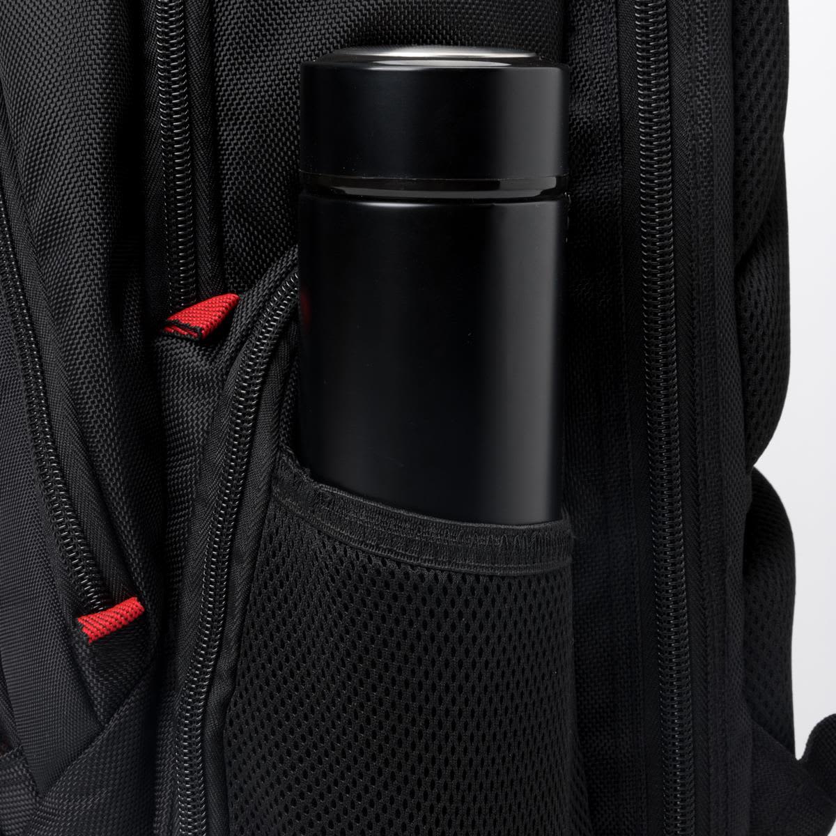 A black drink bottle is nestled in the mesh side pocket of a black backpack featuring red accents and a logo.