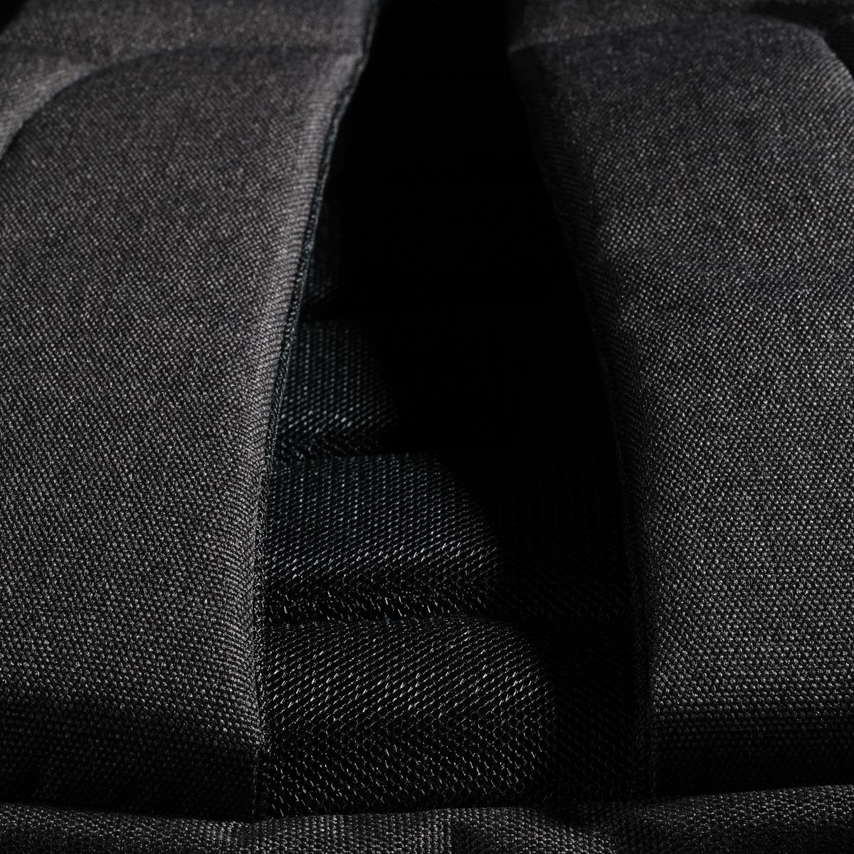 A close-up of the Swissdigital Arosa Backpack's padded back panel in black fabric, featuring mesh detailing.