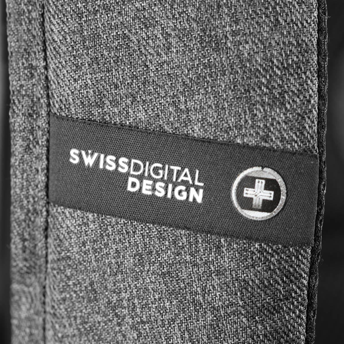 A close-up of a textured grey fabric with a logo patch featuring Swissdigital Design branding.
