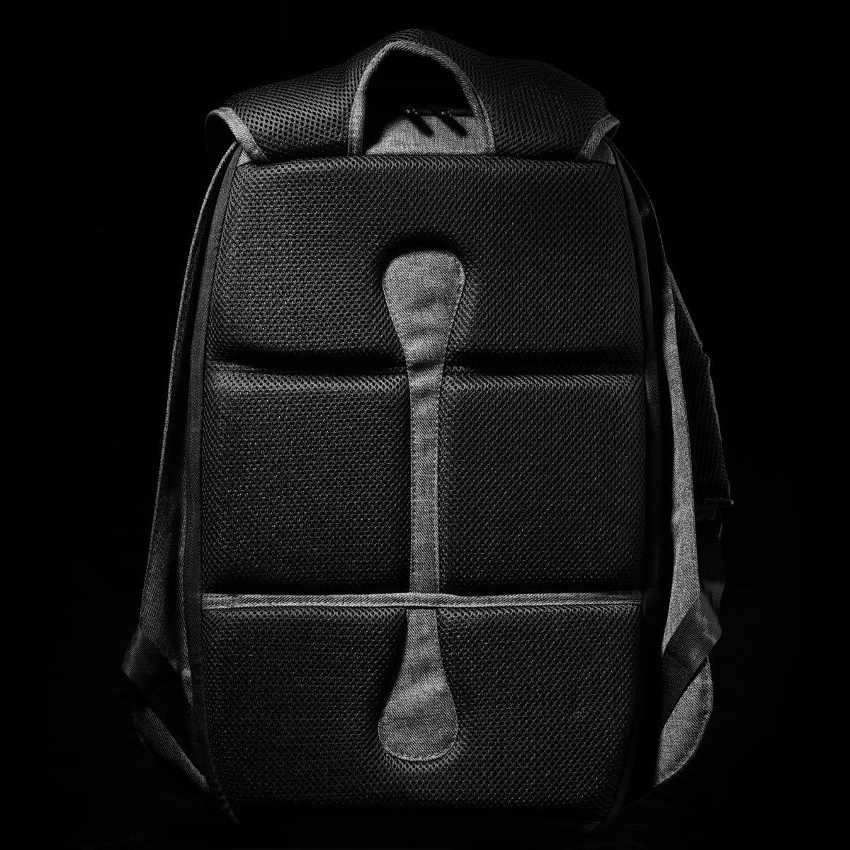 A black backpack with a textured surface and padded back. It features a contoured design and adjustable straps.