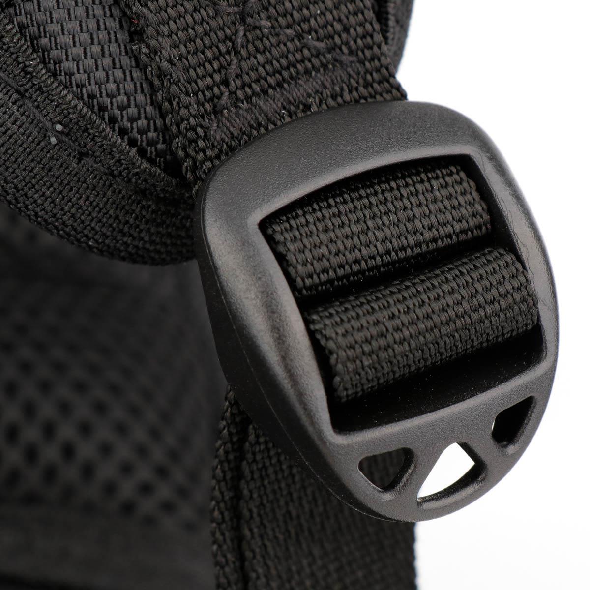 A close-up of a black backpack strap featuring a plastic buckle detail.