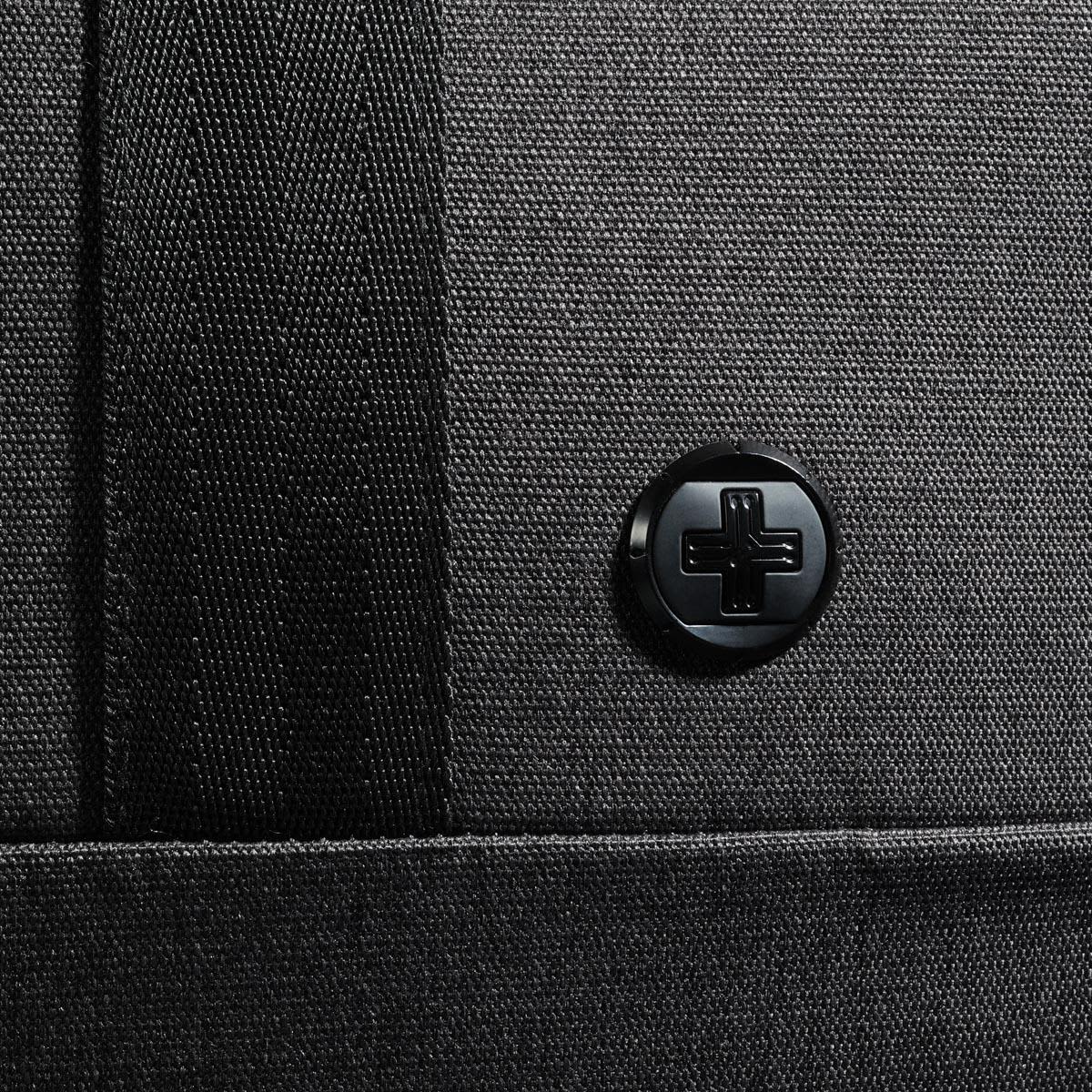 A black duffle bag with a textured surface and a circular logo on the side.