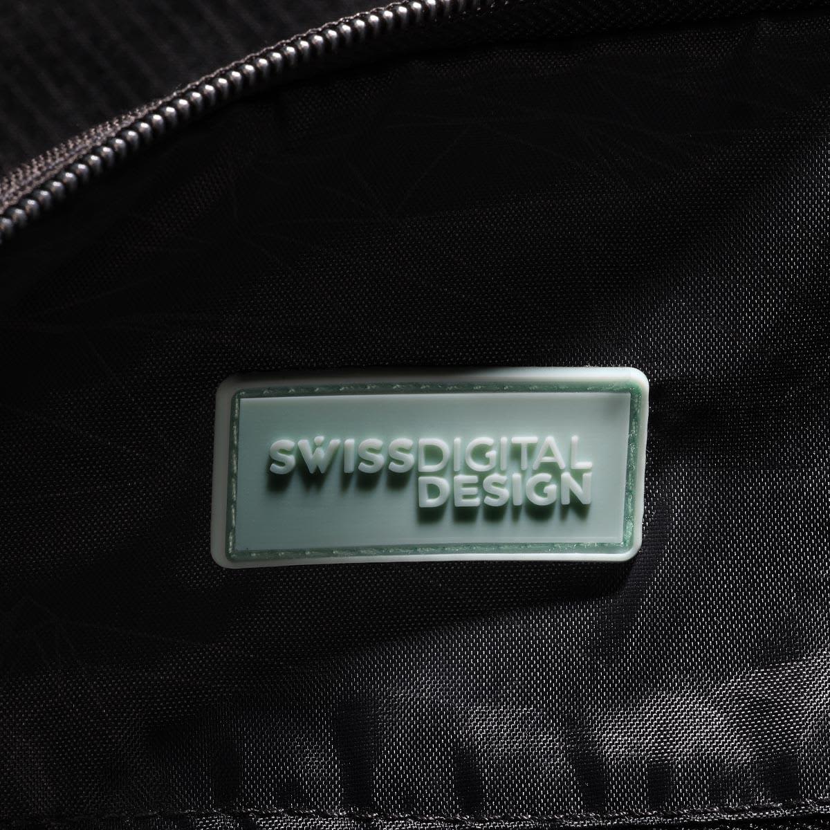 A close-up of the interior of a black duffle bag featuring a branded logo tag.
