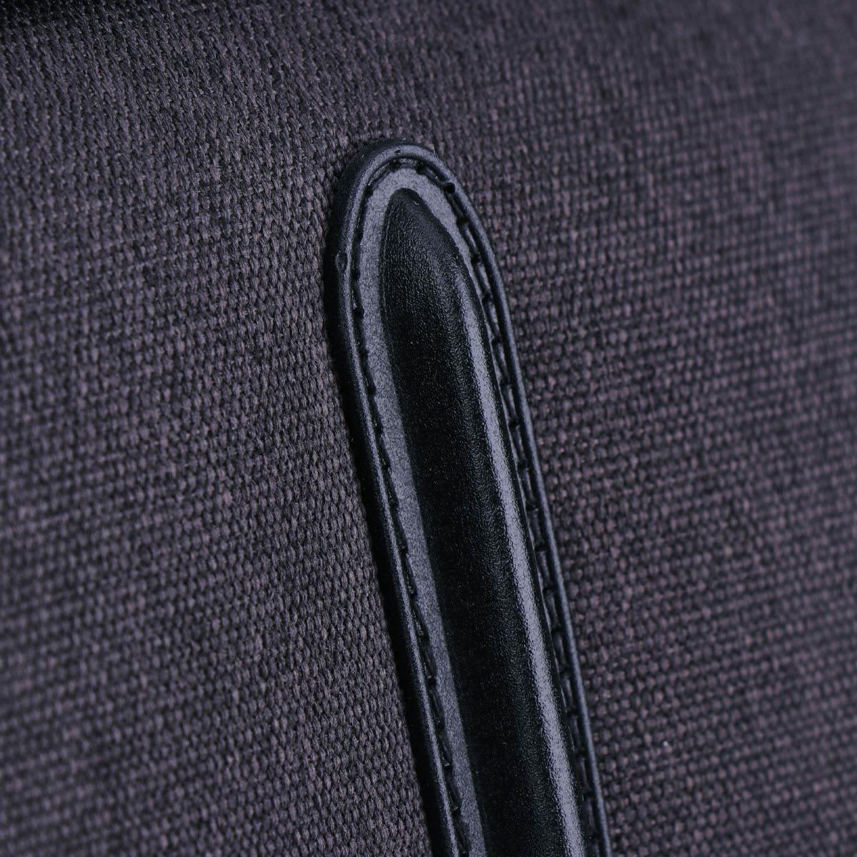 A close-up of a dark grey fabric with a black leather accent, part of the Swissdigital Arosa Duffle Bag.