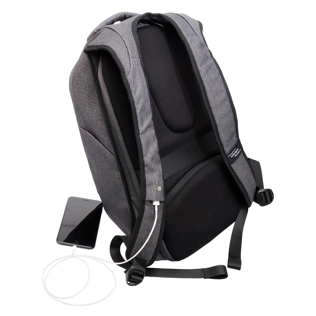 A grey anti-theft backpack with adjustable straps, featuring a charging port and a smartphone beside it.