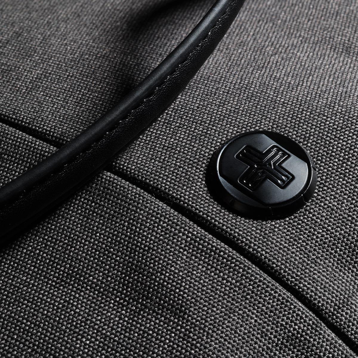A grey tote bag with a black handle and a circular black logo on the front.