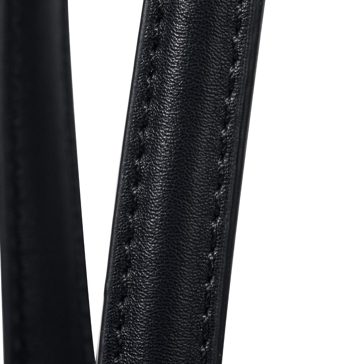 Close-up of a black, textured strap from a tote bag, featuring detailed stitching. The bag has a logo on it.