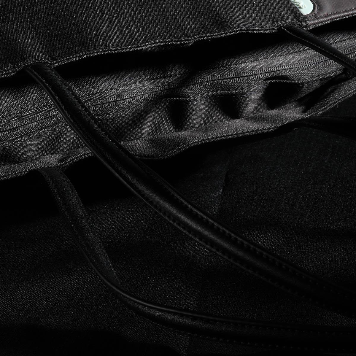 A black tote bag featuring interior pockets and long handles, with a logo on the exterior.