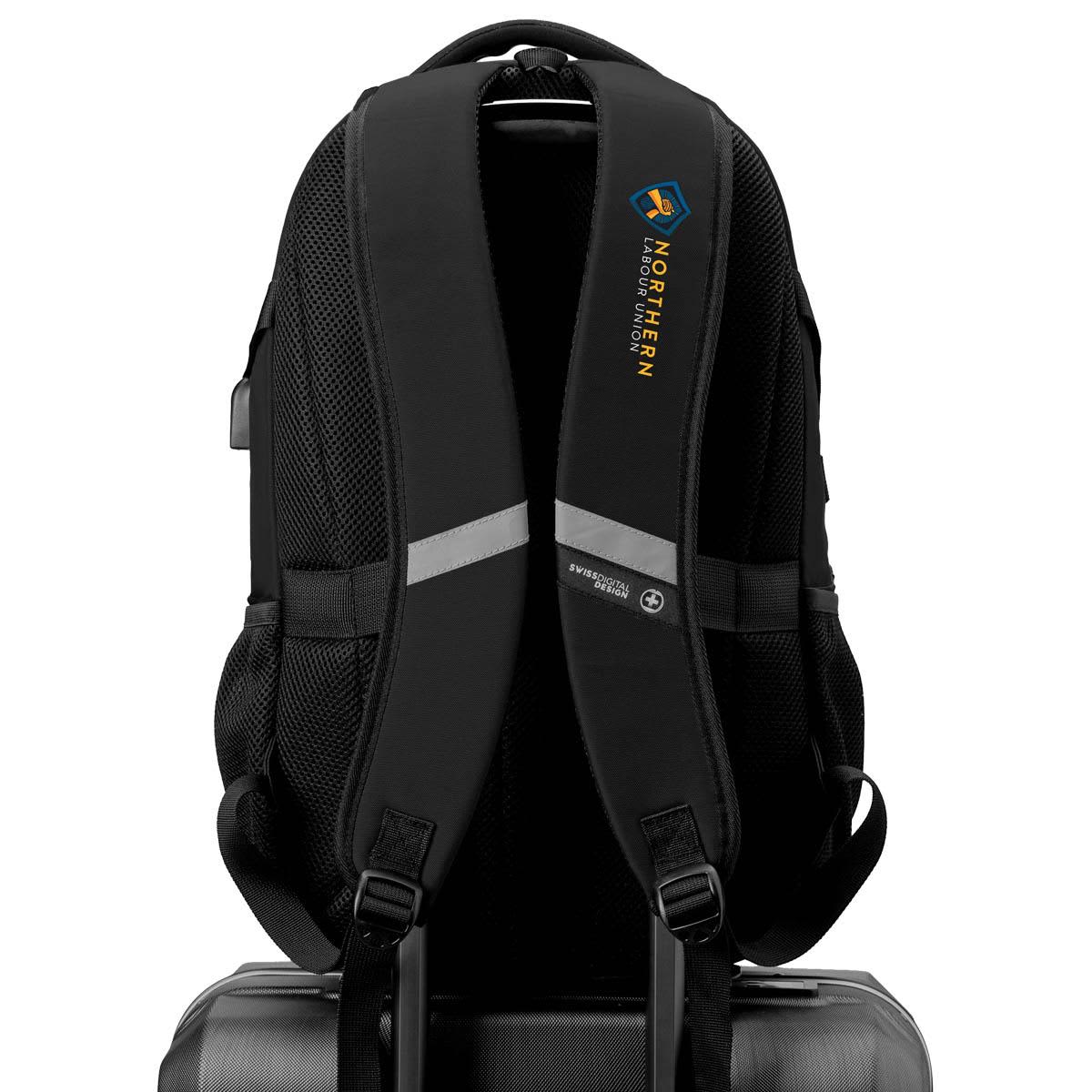 A black Swissdigital Vector Backpack featuring padded straps and a logo, resting on a suitcase.