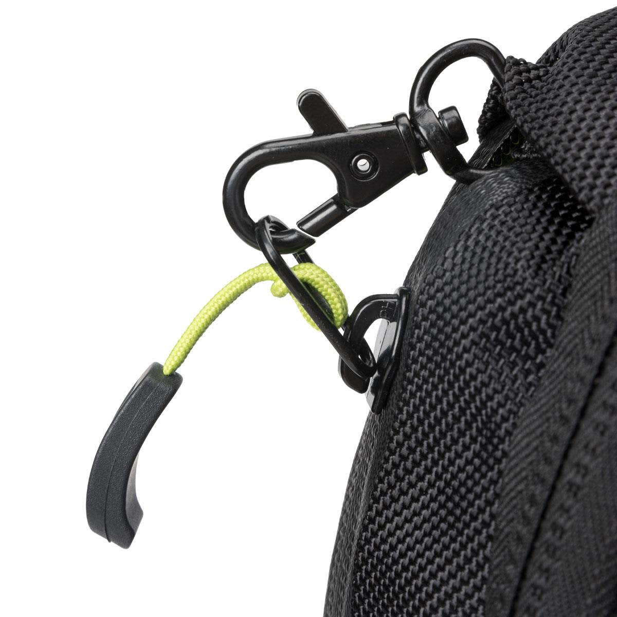A close-up of a black backpack with a green accent on the zipper pull and a metal clip.
