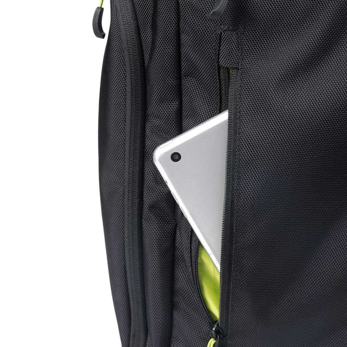 A silver tablet peeks out from the side pocket of a black Swissdigital Java Backpack.
