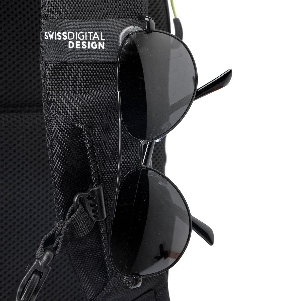 A black backpack featuring a front pocket with sunglasses attached, displaying a logo on the strap.