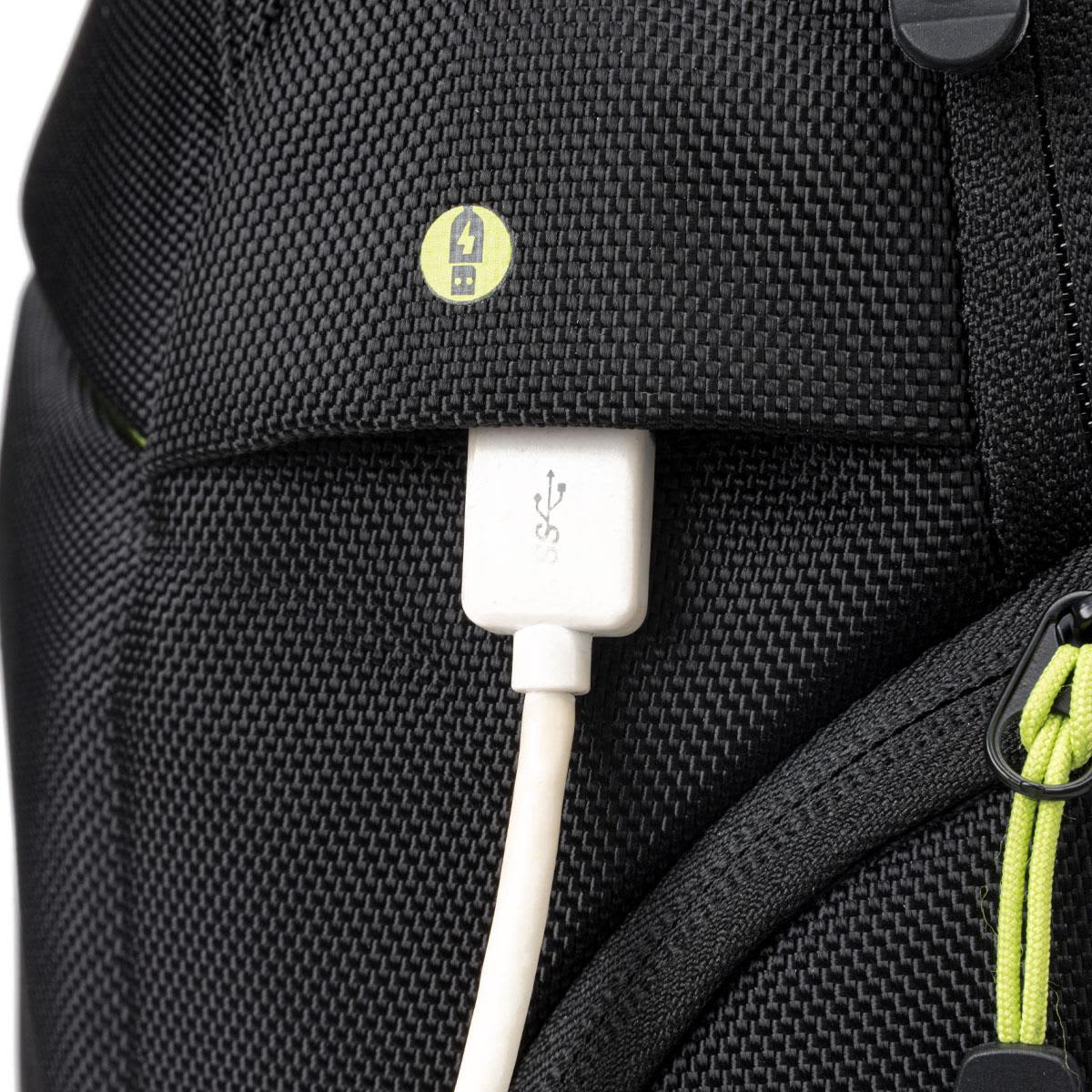 A close-up of the Swissdigital Java Backpack showcasing a USB port and cable against a black exterior with lime green accents.