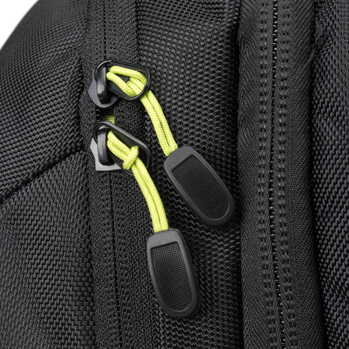 Close-up of a black backpack zipper with bright green pulls, showcasing the textured fabric.