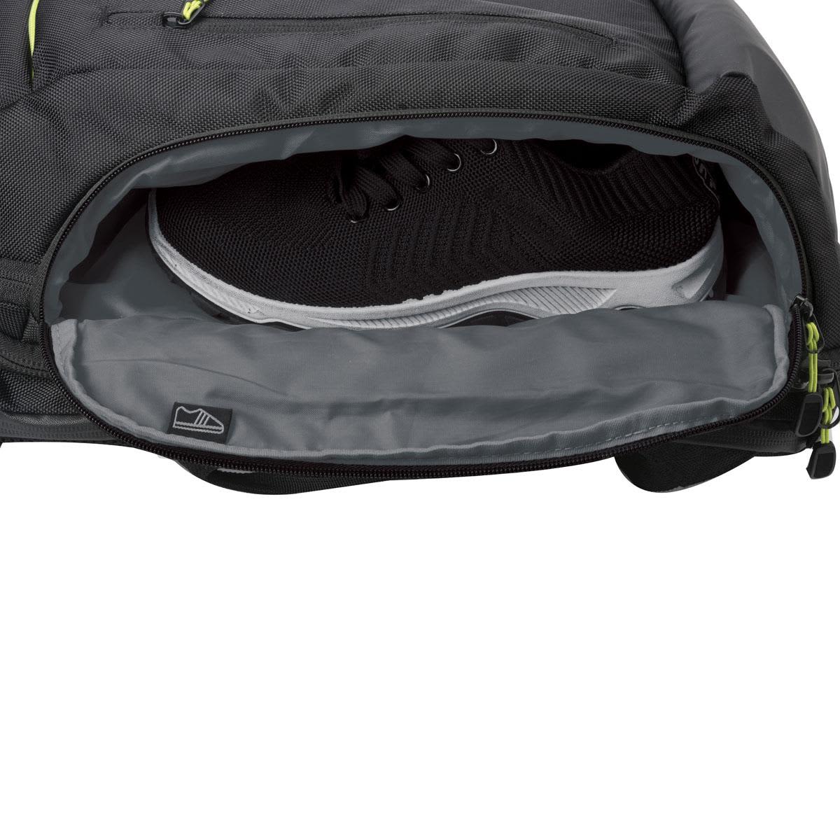 A black Swissdigital Java Backpack with a grey interior, featuring a compartment holding a black sneaker.
