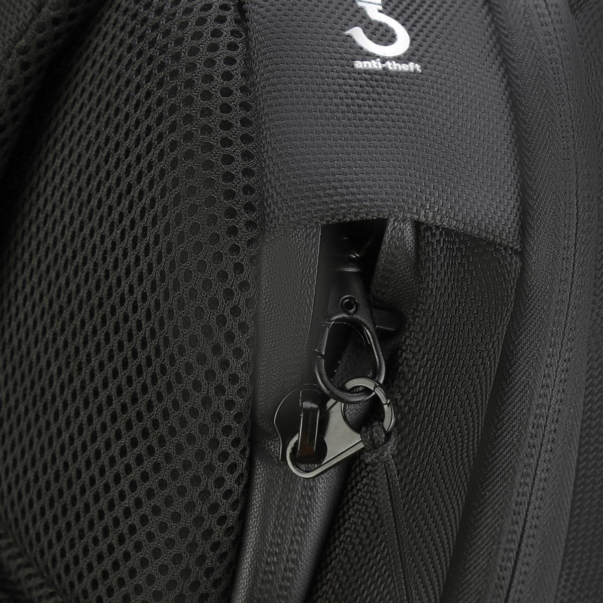 A close-up of a black backpack featuring a zippered pocket and an anti-theft clip.