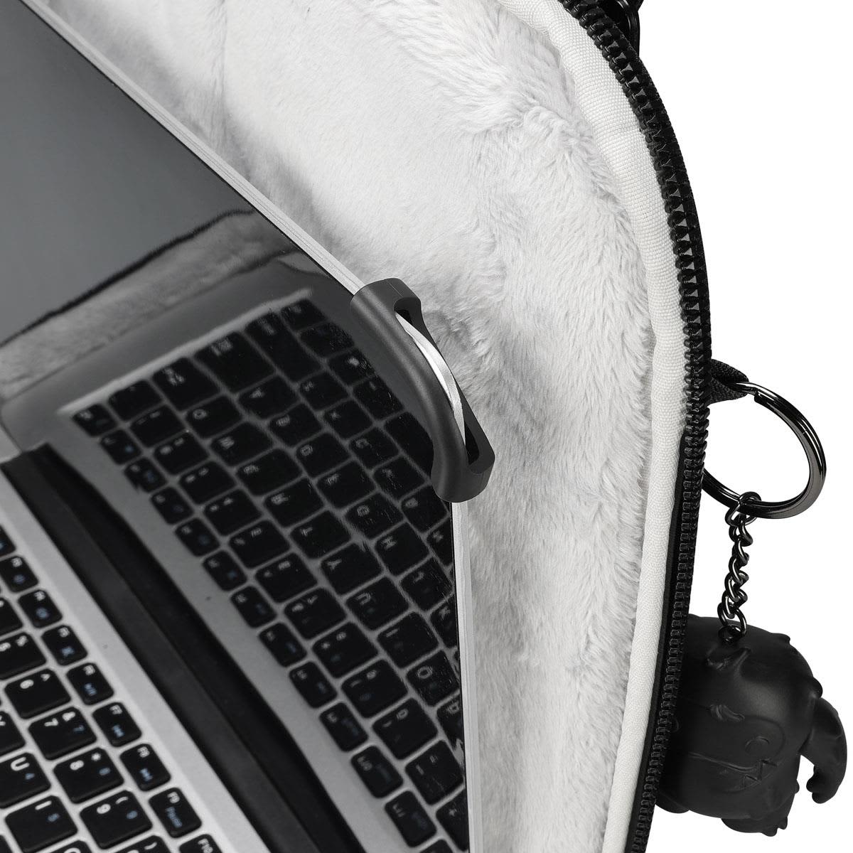 A laptop sleeve in grey with a plush interior and a keychain attachment. It features a black logo.