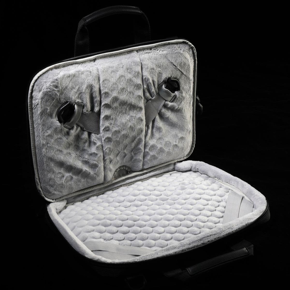 A grey laptop sleeve featuring a soft, padded interior and adjustable straps for securing a device.