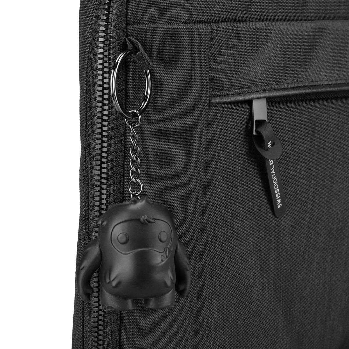 A black laptop sleeve featuring a zipper pocket and a keychain accessory with a cute monster design.