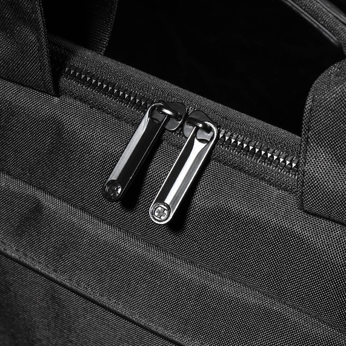 A black laptop sleeve with dual zippers, featuring a sleek and textured fabric design.