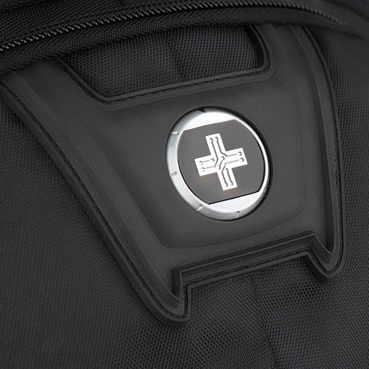 A close-up of a black backpack featuring a circular logo on the front panel.
