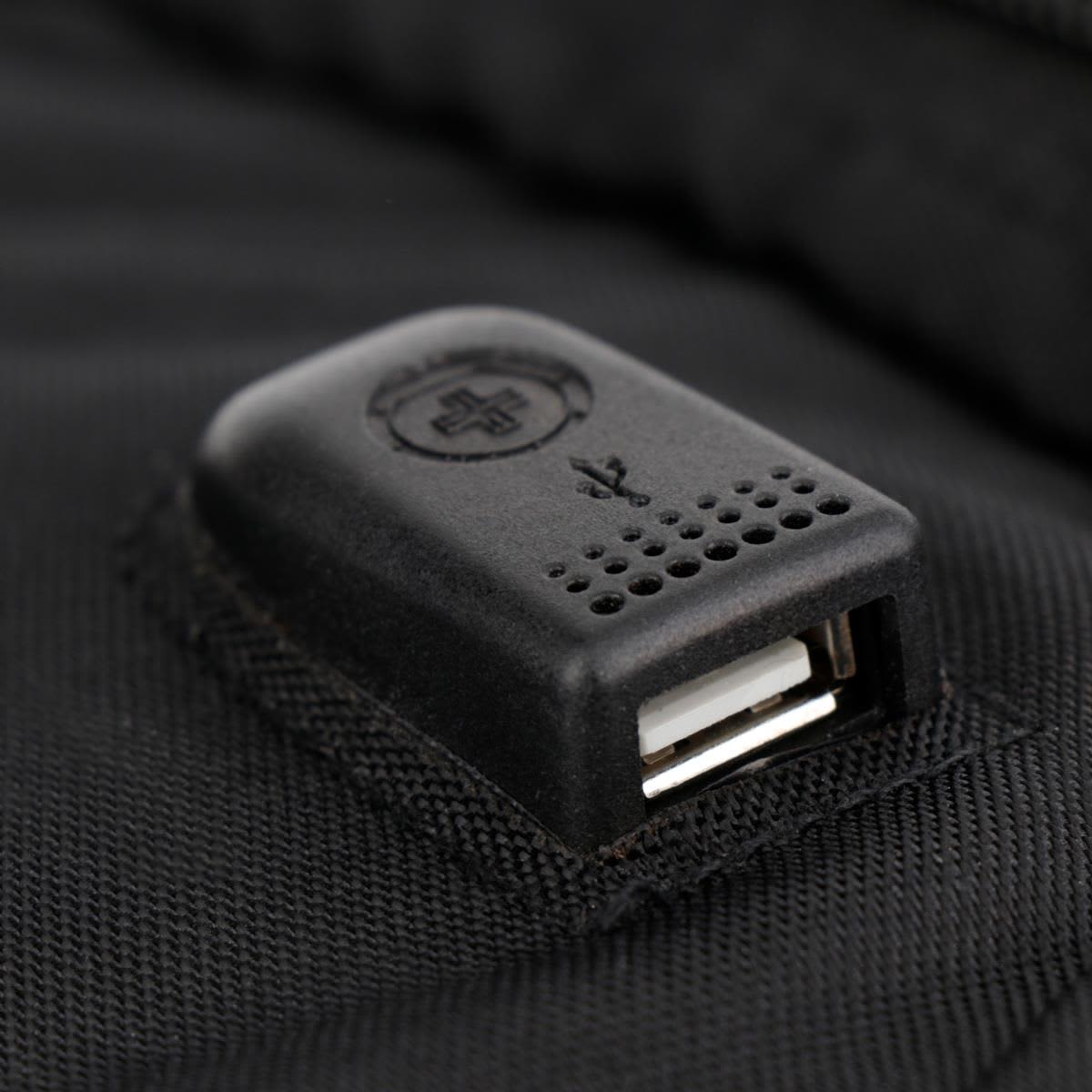 A close-up of a black USB port attached to a backpack, featuring a small branding logo.