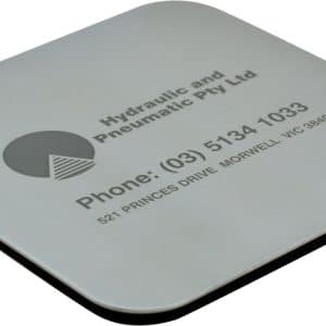 A square metallic coaster featuring a logo and contact information, with a black underside.