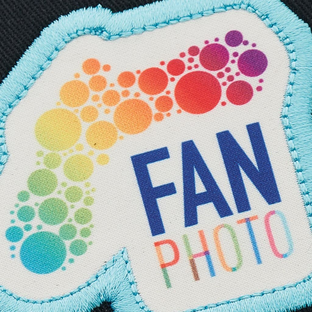 White patch outlined in blue thread with rainbow bubble artwork and “Fan Photo” text, a creative and fun style for best branded merchandise.