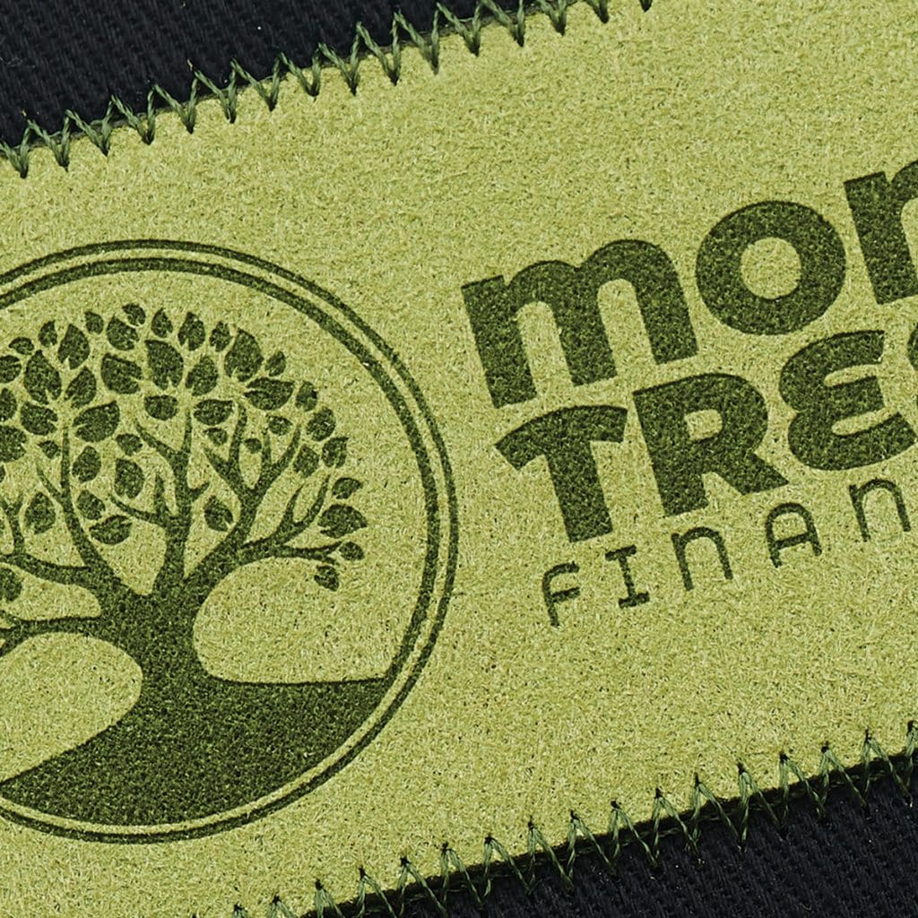 Olive green SupaEtch patch with tree icon and "Money Tree Finance" branding, zigzag stitched for a raw-edge look.