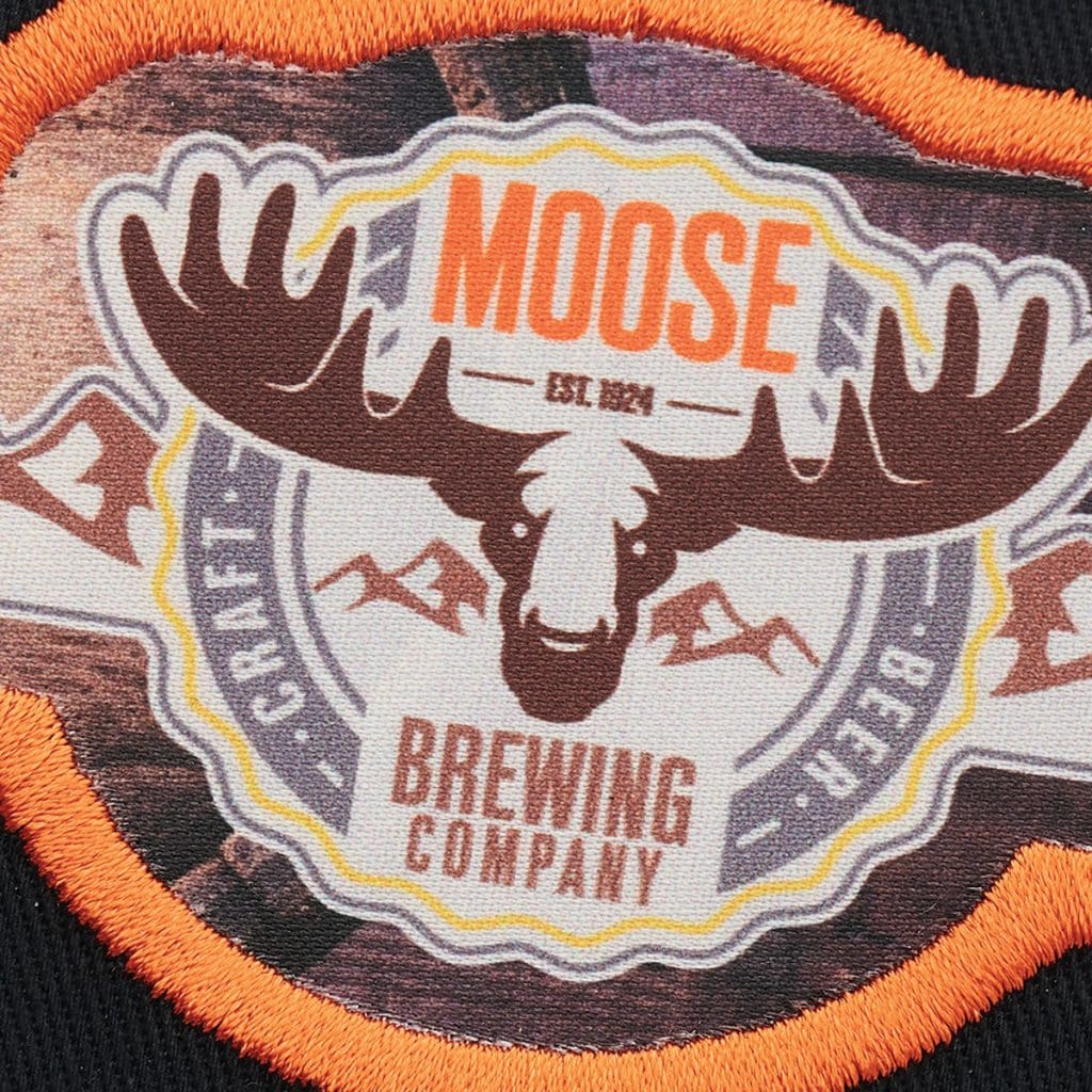 Patch showing a stylised moose with “Moose Brewing Company” text and orange border, representing rustic best branded merchandise for breweries.