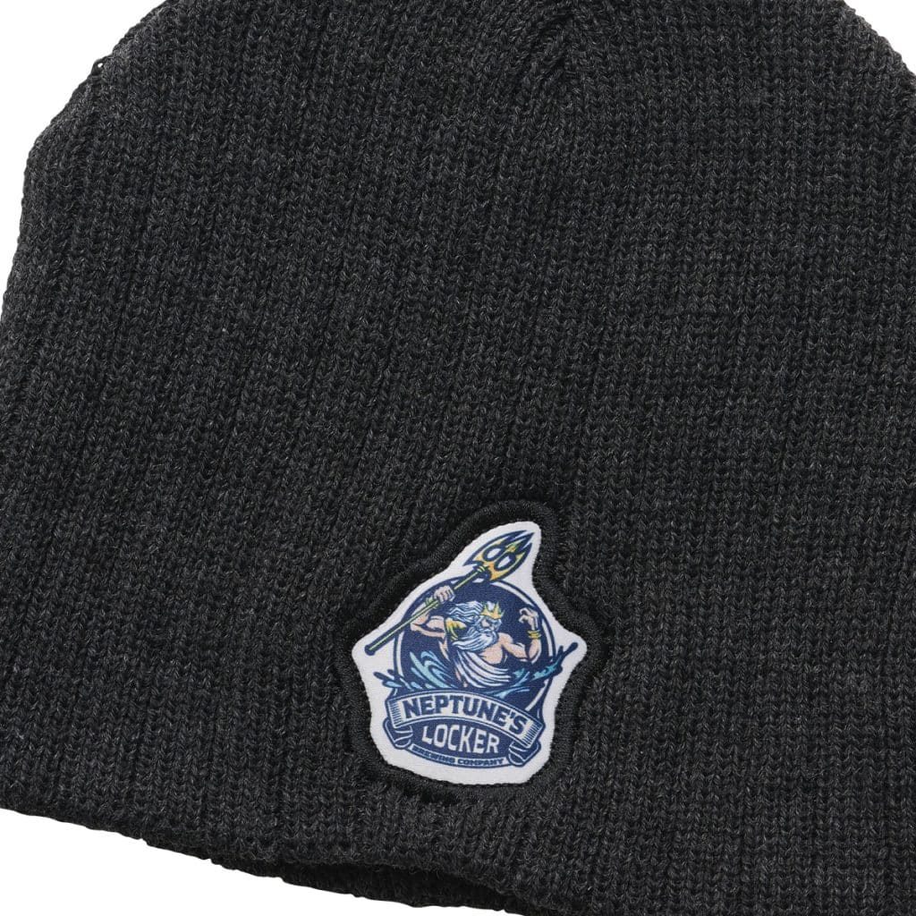 Dark beanie with an ocean-themed patch showing Neptune holding a trident, a unique approach to embroidered best branded merchandise.