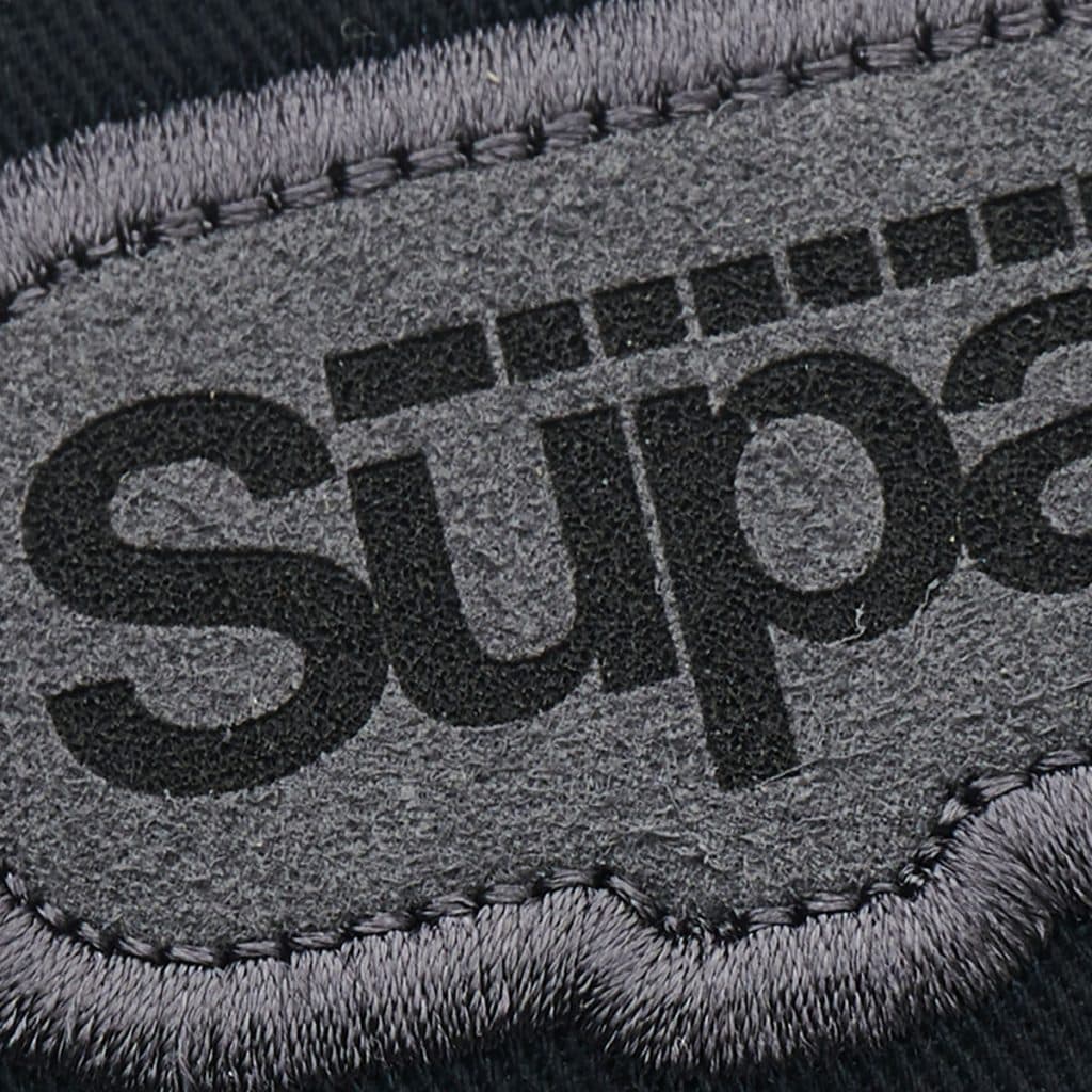 Detailed grey patch showing SupaEtch branding, highlighting suede texture and precision etching.