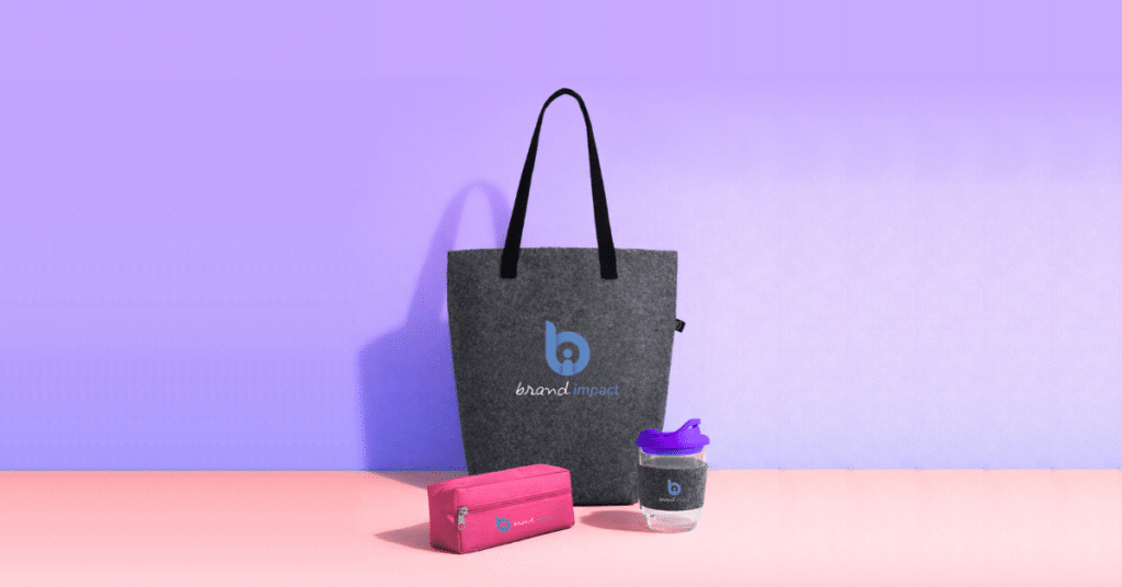 Branded merchandise set including a felt tote bag, pencil case, and reusable drink cup with logo, representing custom promotional products and corporate branded gifts.