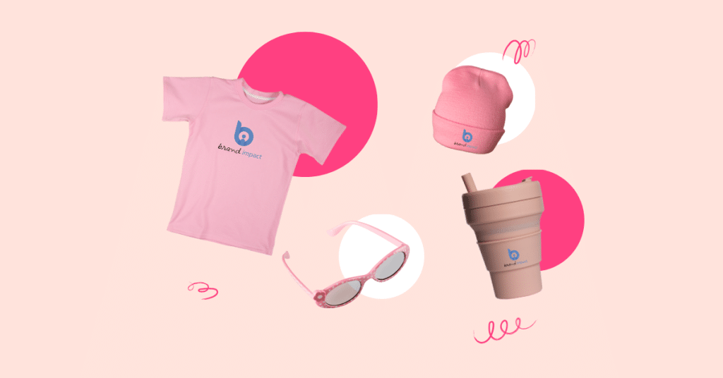 Pink-themed branded merchandise including custom t-shirt, beanie, sunglasses and reusable drink cup with logo, representing stylish promotional products and branded giveaways.