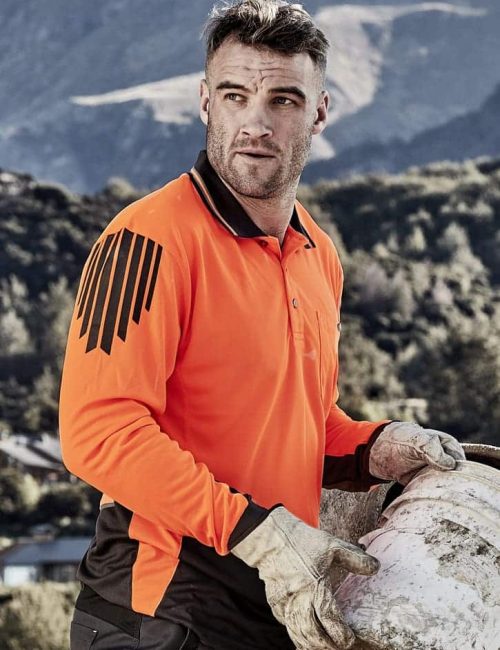 A long sleeve polo in high visibility orange and black, featuring a logo and worn by a man outdoors.